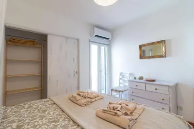a bedroom with a bed and a dresser and a mirror at Downtown & Beach in Albufeira