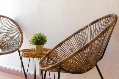 a rattan chair and a table with a potted plant at Downtown & Beach in Albufeira