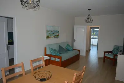 a living room with a couch and a table at Apartamento Azul in Quarteira