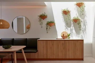 a room with a mirror and potted plants on the wall at Bougainvillea 33 by My Cozy Home in Faro