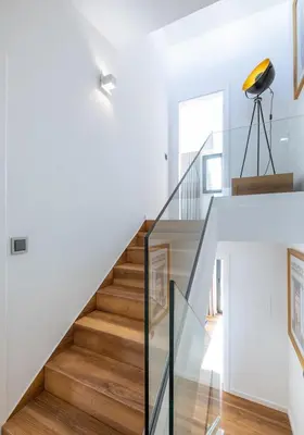 a white staircase with wood floors and a glass railing at Medusa Luxury Marina in Vilamoura