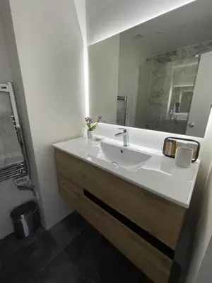a white bathroom with a sink and a mirror at Scarlet's Place - 1 bed Victory Village Quinta Do Lago - beach, nature, lakes in Quinta do Lago