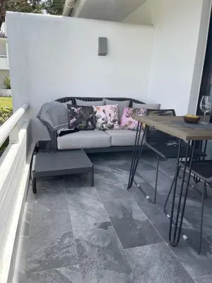 a living room with a couch and a table at Scarlet's Place - 1 bed Victory Village Quinta Do Lago - beach, nature, lakes in Quinta do Lago