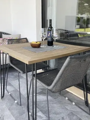 a wooden table with two glasses and a bottle of wine at Scarlet's Place - 1 bed Victory Village Quinta Do Lago - beach, nature, lakes in Quinta do Lago