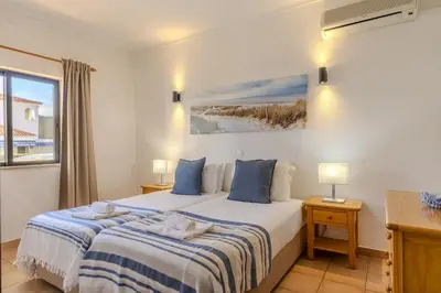 a living room with a blue couch and a table at #014 Mar & Praia Albufeira by Home Holidays in Albufeira