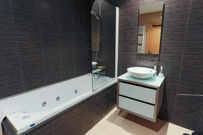 a bathroom with a sink and a mirror and a tub at Marina Vilamoura - Aquamar 214 - By Vilamoura Sun in Vilamoura