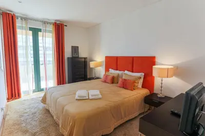 a bedroom with a large bed with two towels on it at Marina Vilamoura - Aquamar 214 - By Vilamoura Sun in Vilamoura