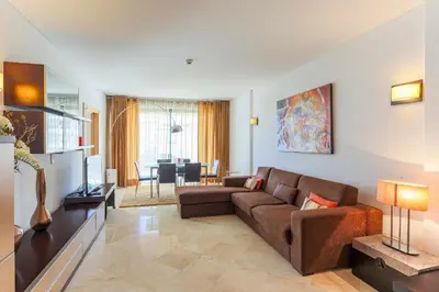 a living room with a brown couch and a table at Marina Vilamoura - Aquamar 214 - By Vilamoura Sun in Vilamoura