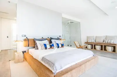 a living room with a spiral staircase and a dining room at Villa Luxueuse Vue Mer in Albufeira