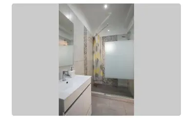 a white bathroom with a sink and a shower at BeGuest Casetta Cleo in Páteo
