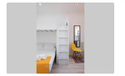 a bedroom with a bunk bed and a yellow chair at BeGuest Casetta Cleo in Páteo