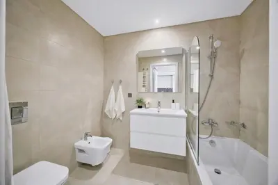 a bathroom with a toilet and a sink and a shower at Bright Modern Beachside Apartment with Pool & Seaview in Quarteira
