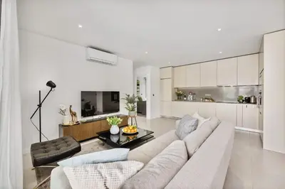 a living room with a couch and a table at 2-Bedroom Beachside Apartment with Pool & Parking in Quarteira
