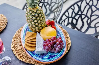 a plate of food with fruit and crackers on a table at 2-Bedroom Beachside Apartment with Pool & Parking in Quarteira