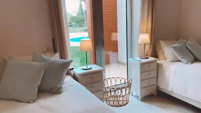 a bedroom with two beds and a window with a view at THE PALM at the Palm Village 2 Bedrooms Apartment in Vilamoura