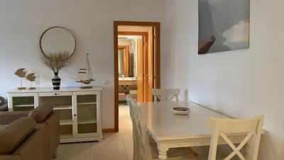 a living room with a table and a couch at THE PALM at the Palm Village 2 Bedrooms Apartment in Vilamoura