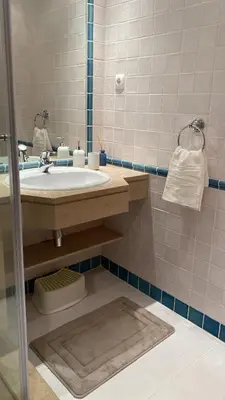 a bathroom with a sink and a mirror at THE PALM at the Palm Village 2 Bedrooms Apartment in Vilamoura