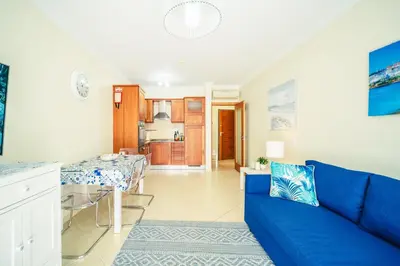 a living room with a blue couch and a table at Albufeira - Cerro Mar Star - Cozy and Relaxing T1 in Albufeira