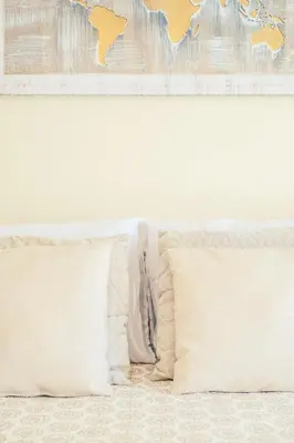 two pillows on a bed with a map on the wall at Albufeira - Cerro Mar Star - Cozy and Relaxing T1 in Albufeira