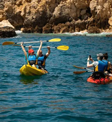 a group of people in kayaks in the water at Albufeira - Cerro Mar Star - Cozy and Relaxing T1 in Albufeira