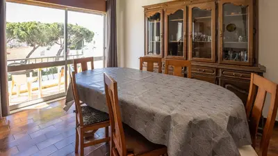 a dining room with a table and a large window at Apartamento Tio Pedro - by bedzy in Albufeira