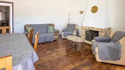a living room with a couch and a fireplace at Apartamento Tio Pedro - by bedzy in Albufeira