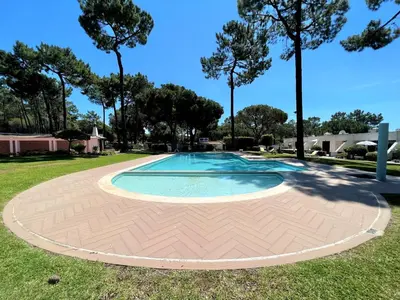 a swimming pool in a park with trees at Vilamoura Golf Studio With Pool by Homing in Vilamoura