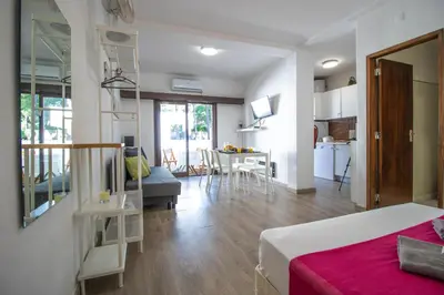 a bedroom with a bed and a living room at Vilamoura Golf Studio With Pool by Homing in Vilamoura