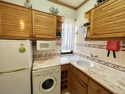 a kitchen with a white refrigerator and a sink at Talia XII - Near the beach by HD PROPERTIES in Vilamoura