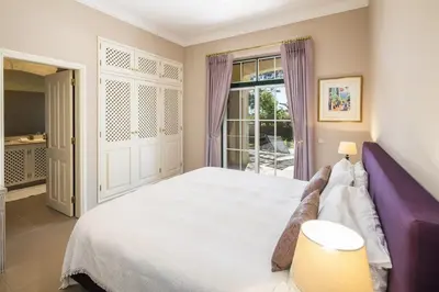 a bedroom with a large bed and a window at Sera - Luxury 3 bedroom apartment with pool, golf,beach in Ludo