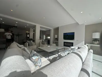 a living room with a couch and a tv at Sunshine - PINHEIROS ALTOS in Quinta do Lago