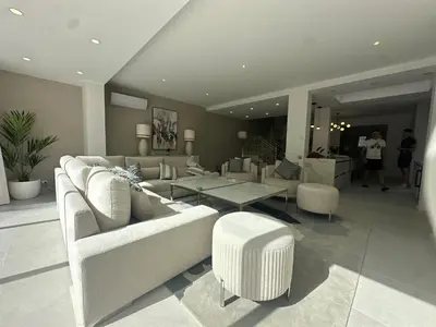 a living room with couches and a table and chairs at Sunshine - PINHEIROS ALTOS in Quinta do Lago