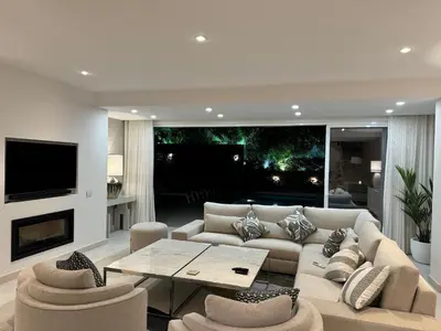 a living room with a couch and a table at Sunshine - PINHEIROS ALTOS in Quinta do Lago