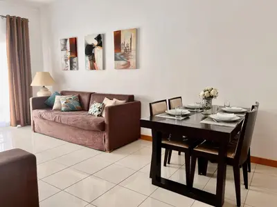 a living room with a table and a couch at Barracuda ByTheSea in Albufeira
