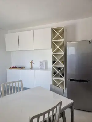 a kitchen with a white table and a refrigerator at AAA T2 Awesome Albufeira Apartments Piscina Marina in Albufeira