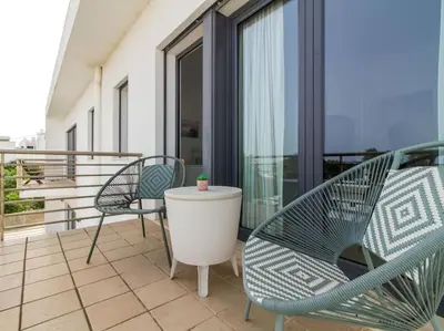 a balcony with chairs and a table on a balcony at Rainbow House by Stay ici Algarve Holiday Rental in Albufeira