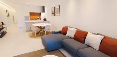 a living room with a couch and a table at 211 Apartamento moderno com vista para a piscina no centro da cidade in Albufeira