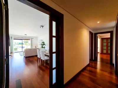 a living room with a table and a dining room at FLH Vilamoura Villa Rosa Golf Apartment with Pool in Vilamoura
