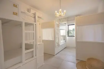 a room with white shelves and a chandelier at Sun Lovers Hostel in Albufeira