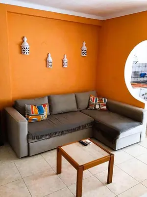 a living room with a couch and a table at 1 Bedroom Apartment Chaves, Praceta Vitorino Nemesio, Albufeira in Albufeira