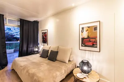 a bedroom with a bed and a couch and a table at BmyGuest - Oura Beach Studio I in Albufeira