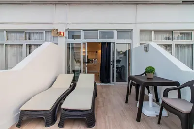a room with two benches and a table at BmyGuest - Oura Beach Studio I in Albufeira