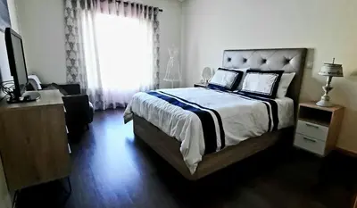 a bedroom with a large bed and a window at Lendas de Portugal in Olhos de Água