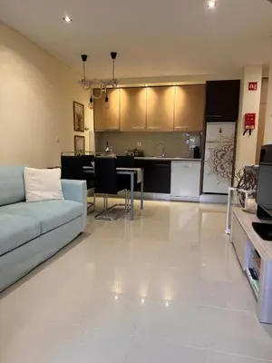 a living room with a couch and a kitchen at Lendas de Portugal in Olhos de Água