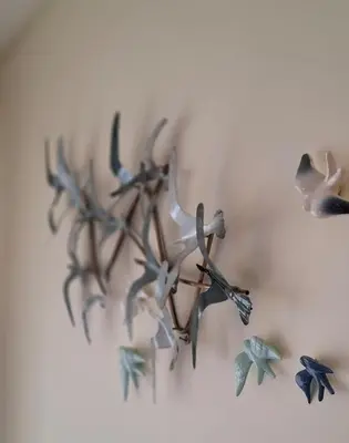 a heart shaped wall decoration with birds on it at Lendas de Portugal in Olhos de Água