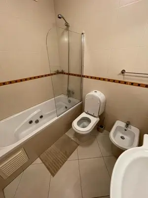 a bathroom with a toilet and a tub and a sink at Vitamin Sea Vilamoura in Quarteira