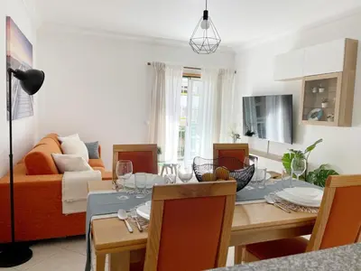 a living room with a table and a couch at Vitamin Sea Vilamoura in Quarteira