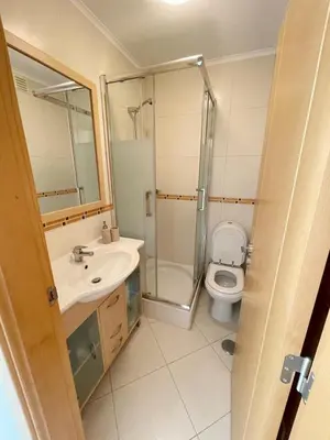 a bathroom with a shower and a toilet and a sink at Vitamin Sea Vilamoura in Quarteira