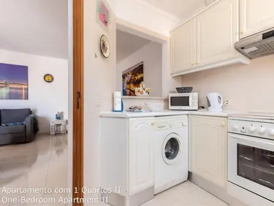 a kitchen with a washer and dryer at Akisol Albufeira Sunny in Roja- Pé