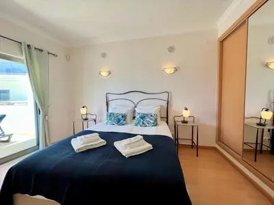a bedroom with a large bed with two towels on it at Albufeira Terrace With Pool by Homing in Albufeira
